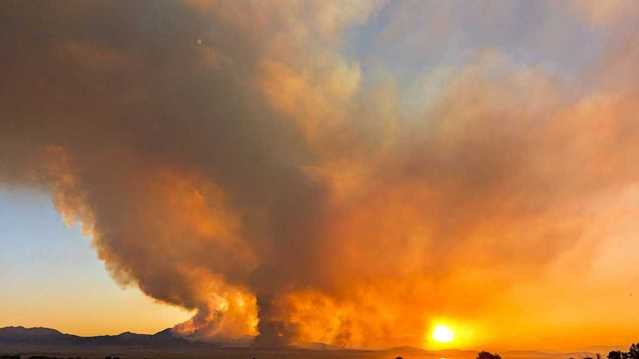 The massive Iron Fire seen from Genola, Utah, June 2026 againsta a setting sun