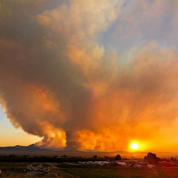 The massive Iron Fire seen from Genola, Utah, June 2026 againsta a setting sun