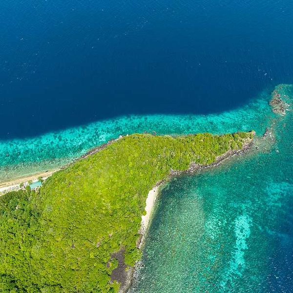 The tip of a spit of land with aqua water surrounding it