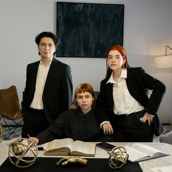 Three attorneys gathered around a desk