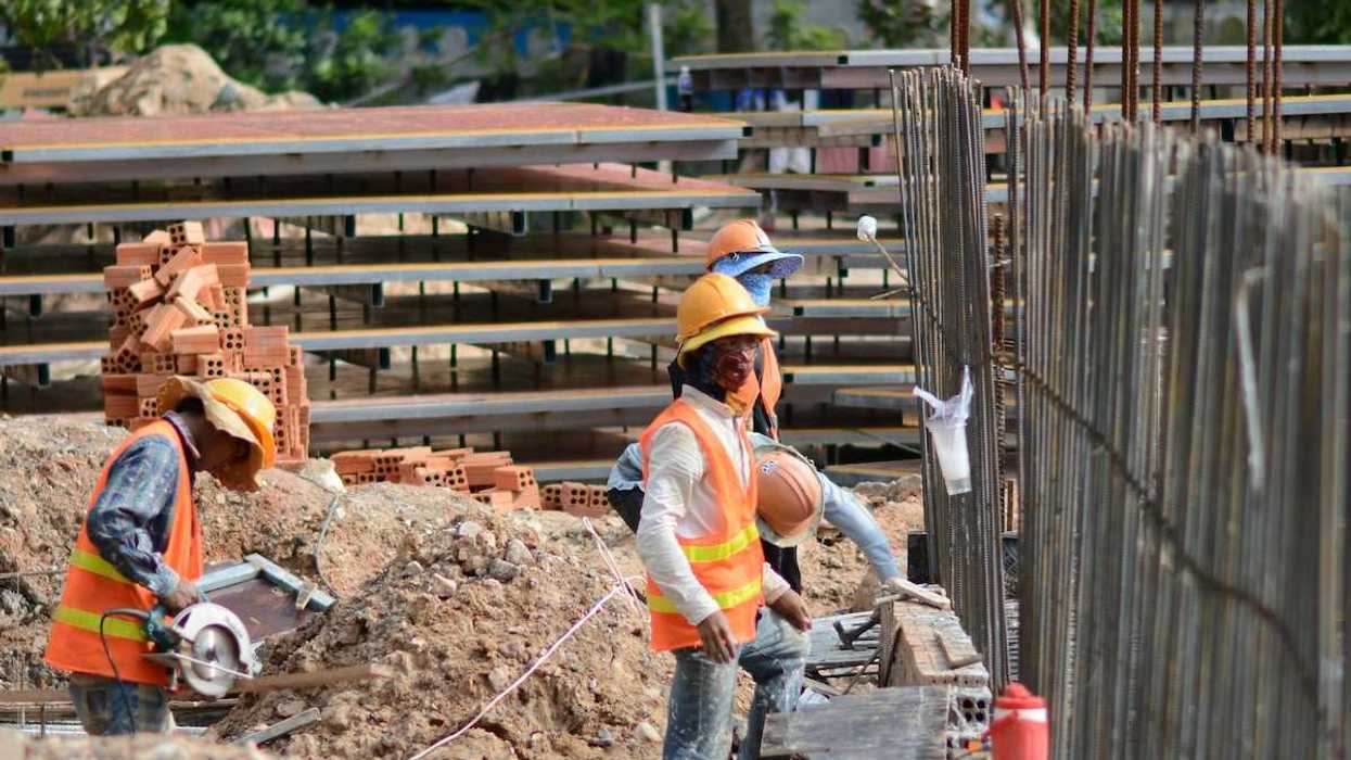 Three construction workers on a job site