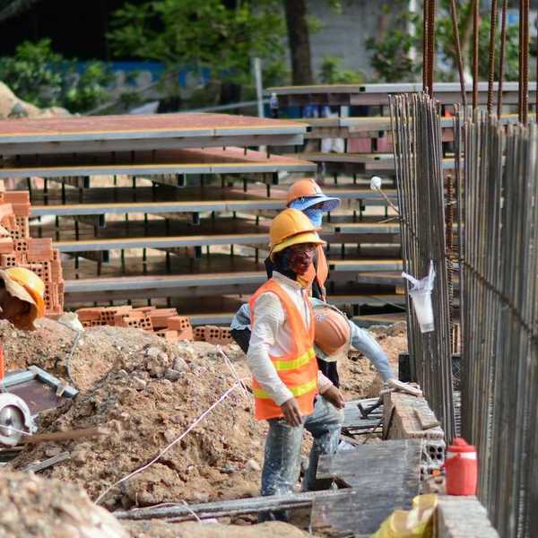 Three construction workers on a job site