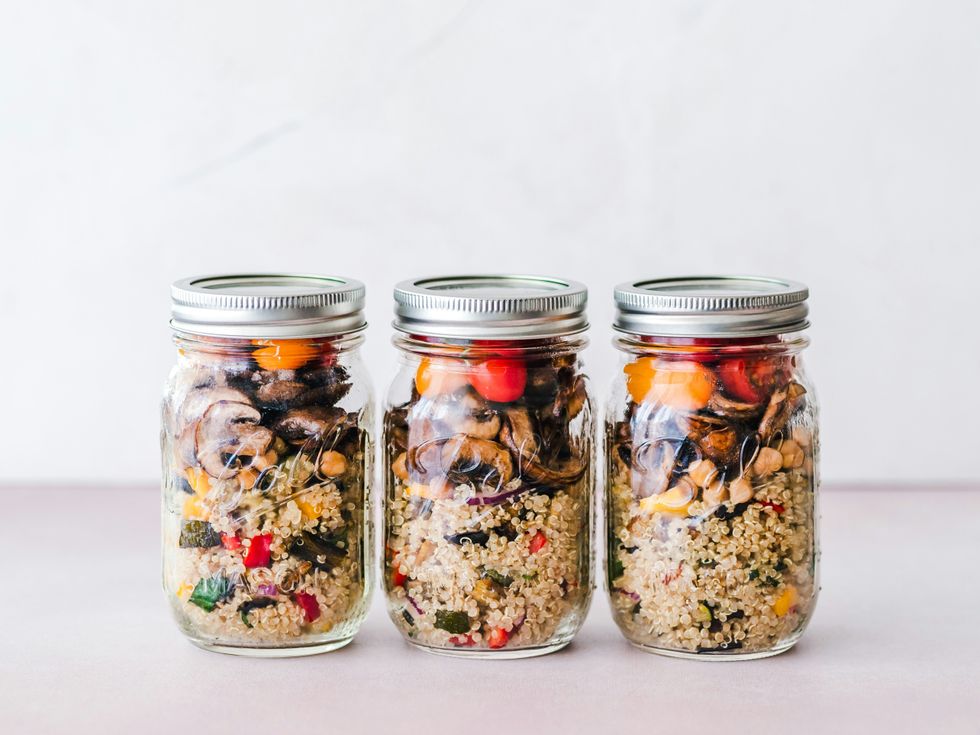 three full clear glass jars full of food with lids.