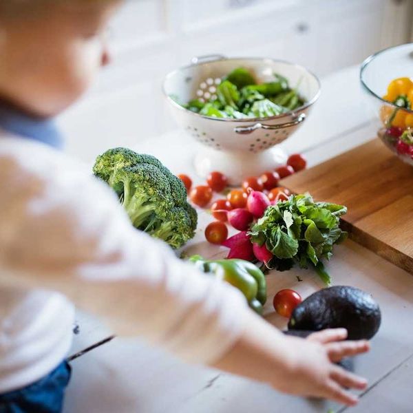 Toddler reaching for fresh fruit and vegetables