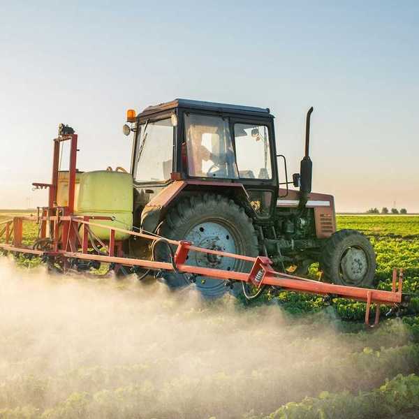Tractor driven application of chemicals on row crops