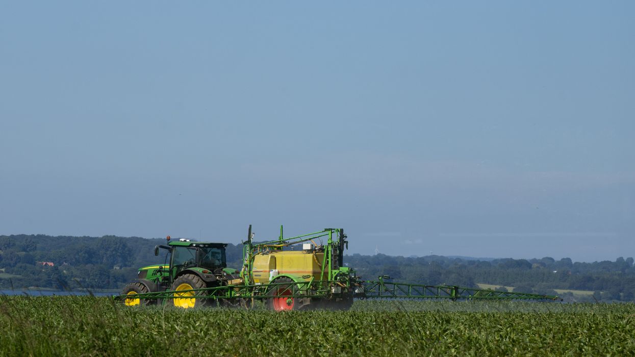 tractor spraying pesticides field