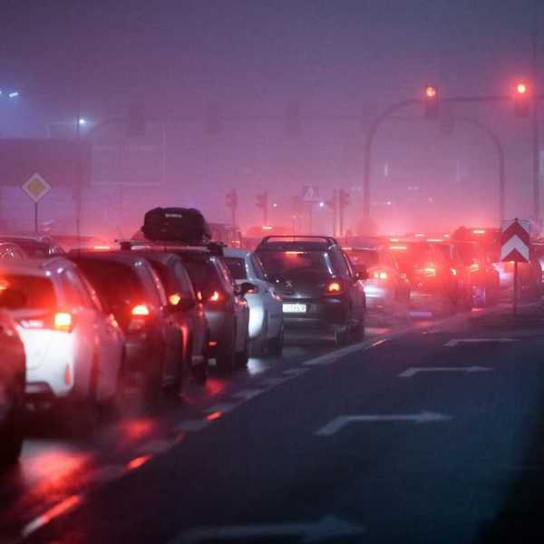 Traffic lined up at stoplight, idling and polluting