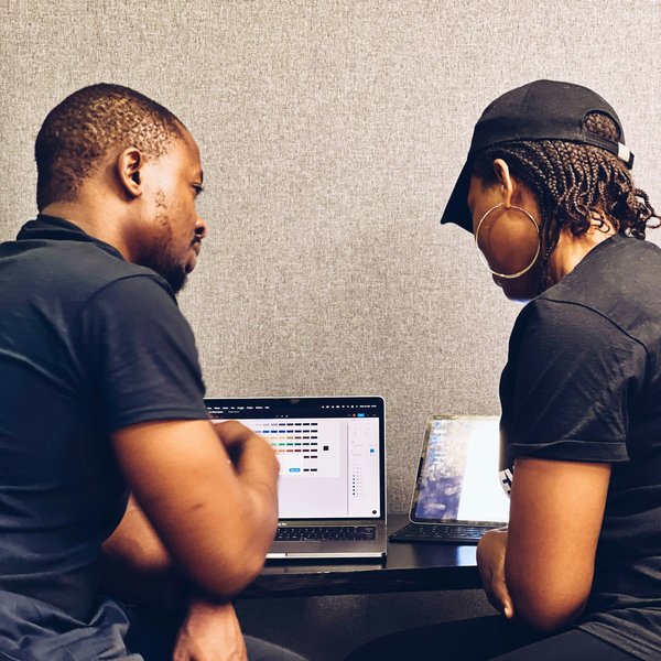 Two Black people looking at a computer