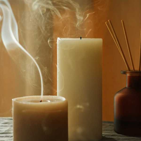 Two candles with extinguished flames continuing to smoke