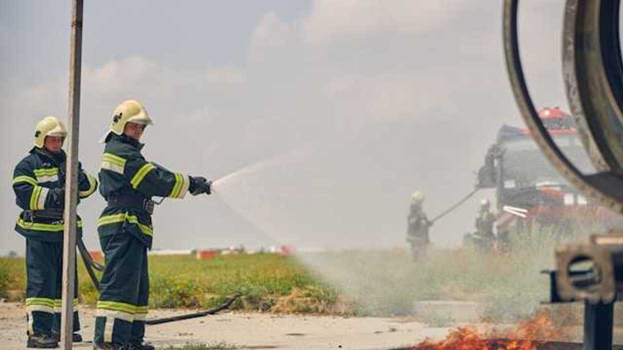 Two firefighters putting out a fire