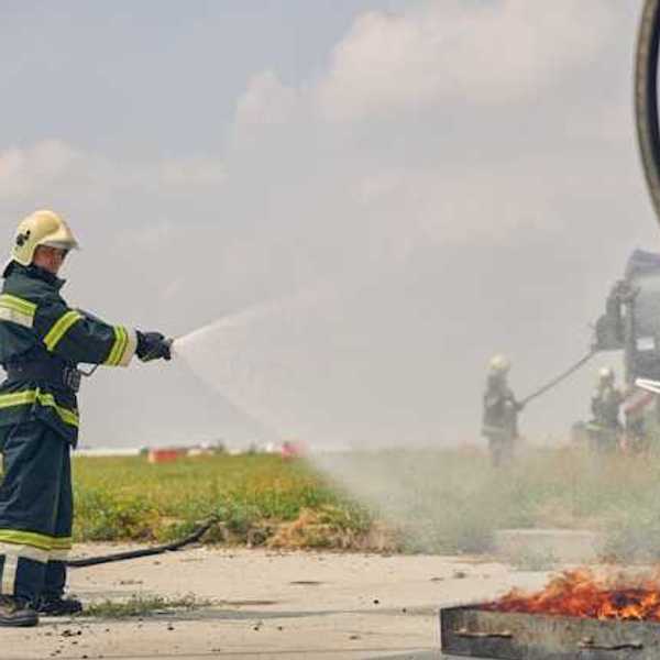 Two firefighters putting out a fire