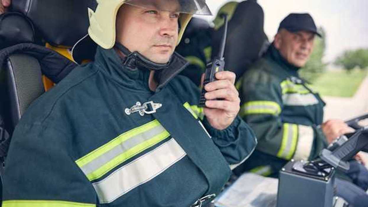 Two firemen sitting in a vehicle