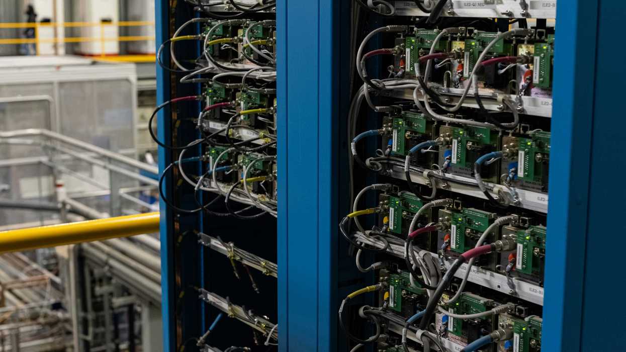 Two server racks filled with electronic components and wires.