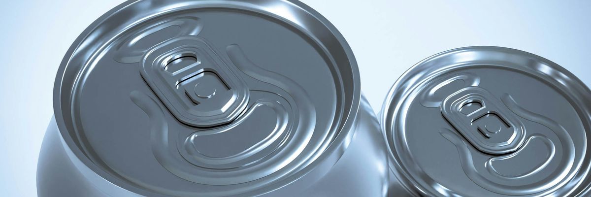 two silver soda cans sitting next to each other