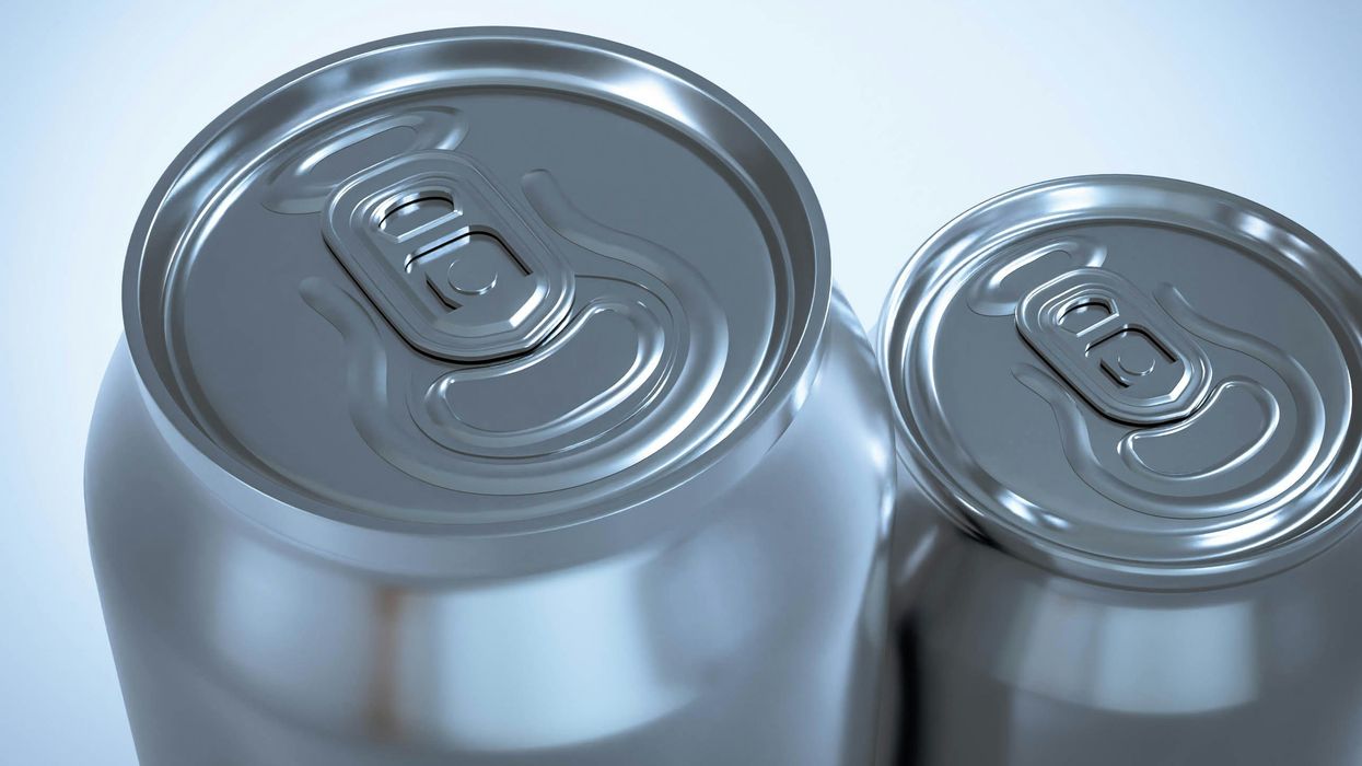 two silver soda cans sitting next to each other