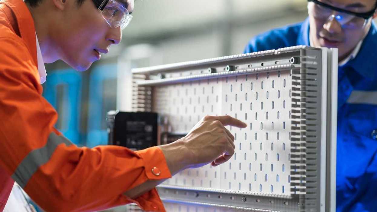 Two technicians working on electrical circuit design