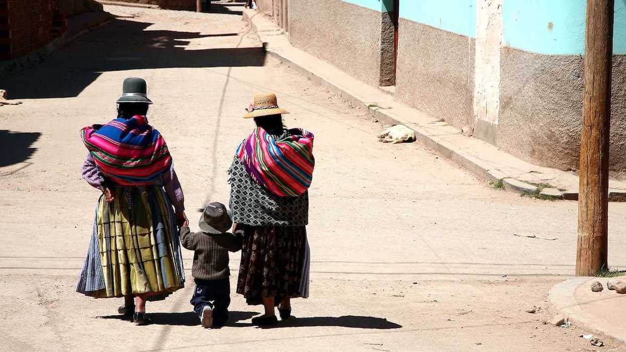 Two women and kid in a street of Copacabana Bolivia