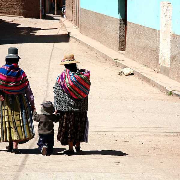 Two women and kid in a street of Copacabana Bolivia