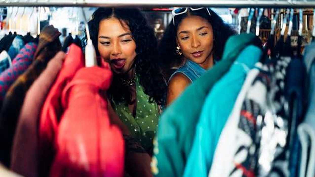 Two women of color looking at clothing on a rack