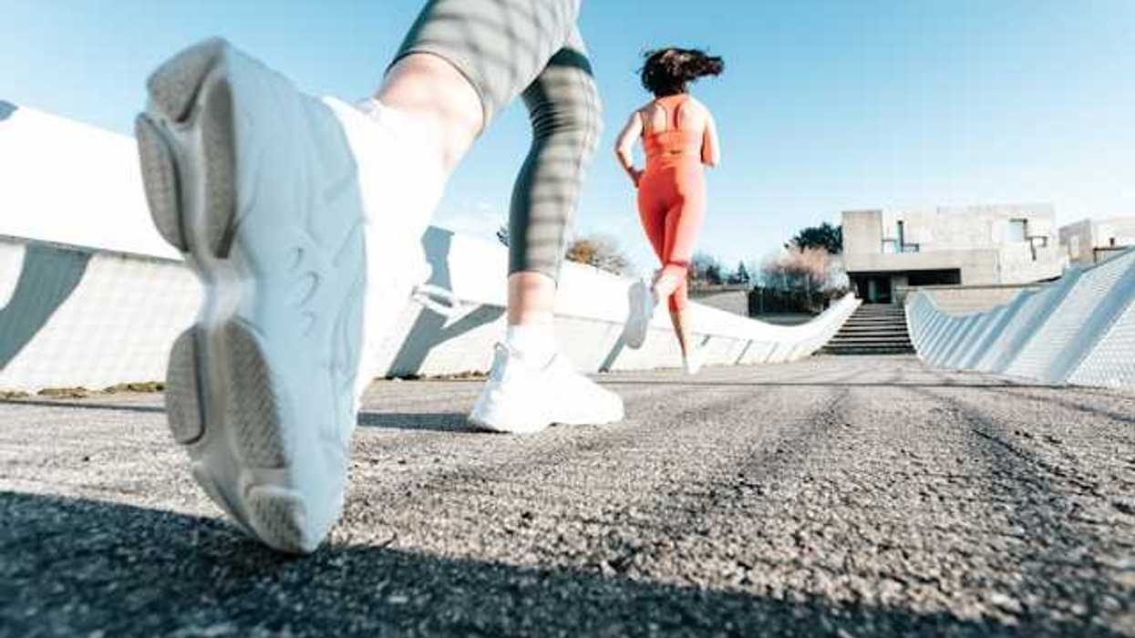 Two women running on a path wearing active wear