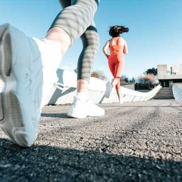Two women running on a path wearing active wear