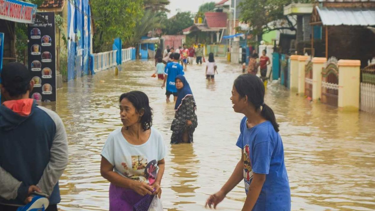 Typhoon victims wade through floodwaters in storm aftermath