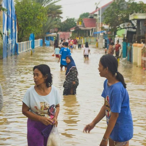 Typhoon victims wade through floodwaters in storm aftermath