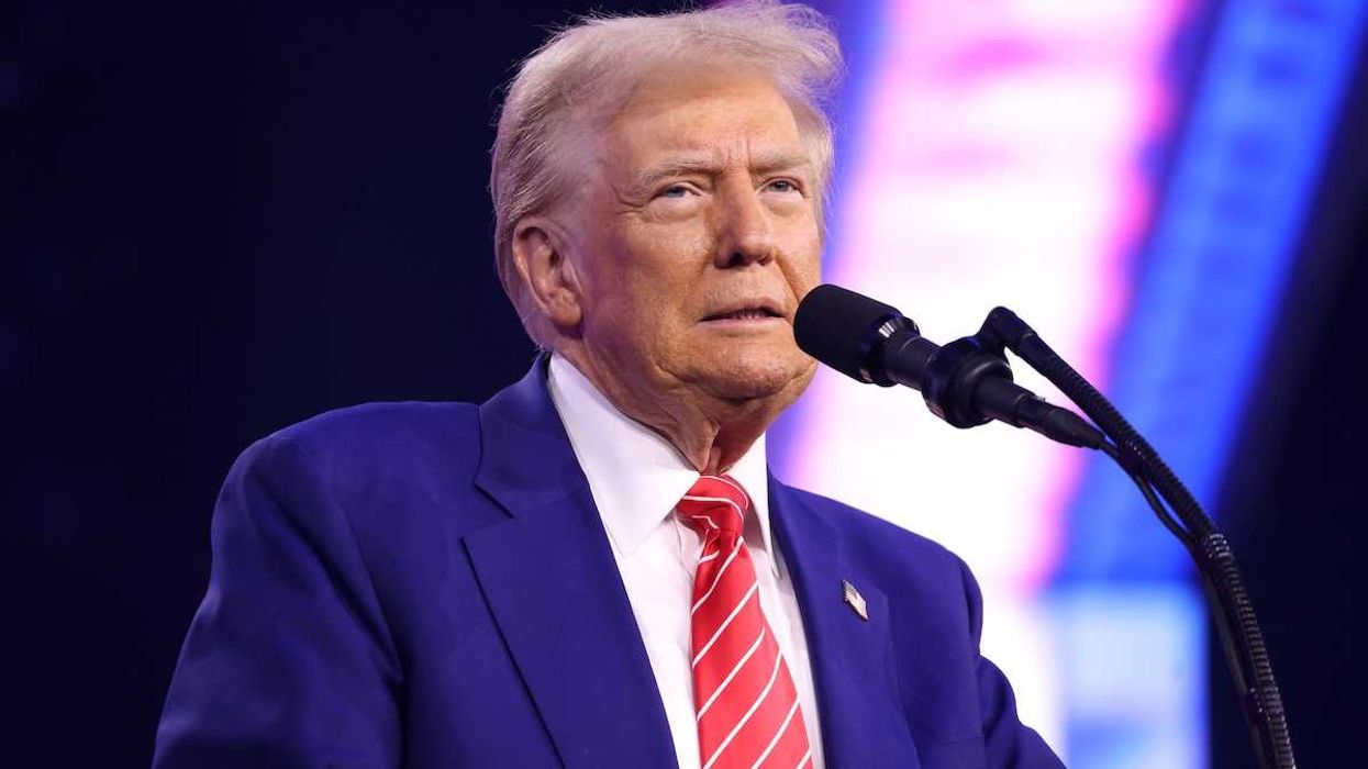 U.S. president Donald Trump speaking into microphone