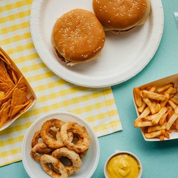 Ultra-processed food: Tortilla chips, fried onion rings, french fries, cheese burgers, and hot dog.