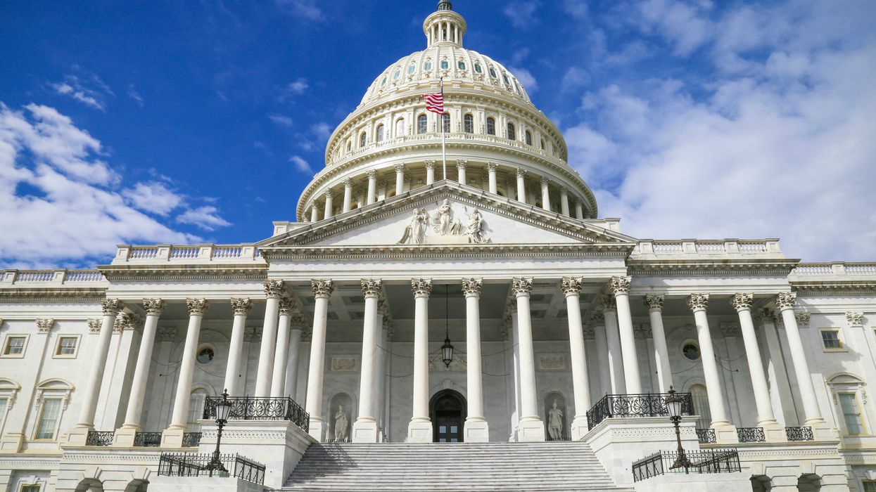 US capitol building against blue sky.