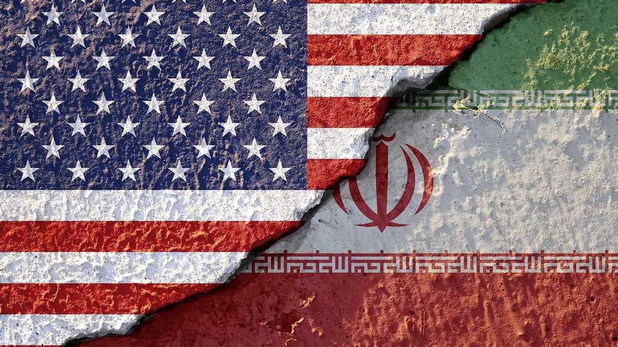 USA flag and Iran flag on cracked wall damage emblematic of USA - Iran War.