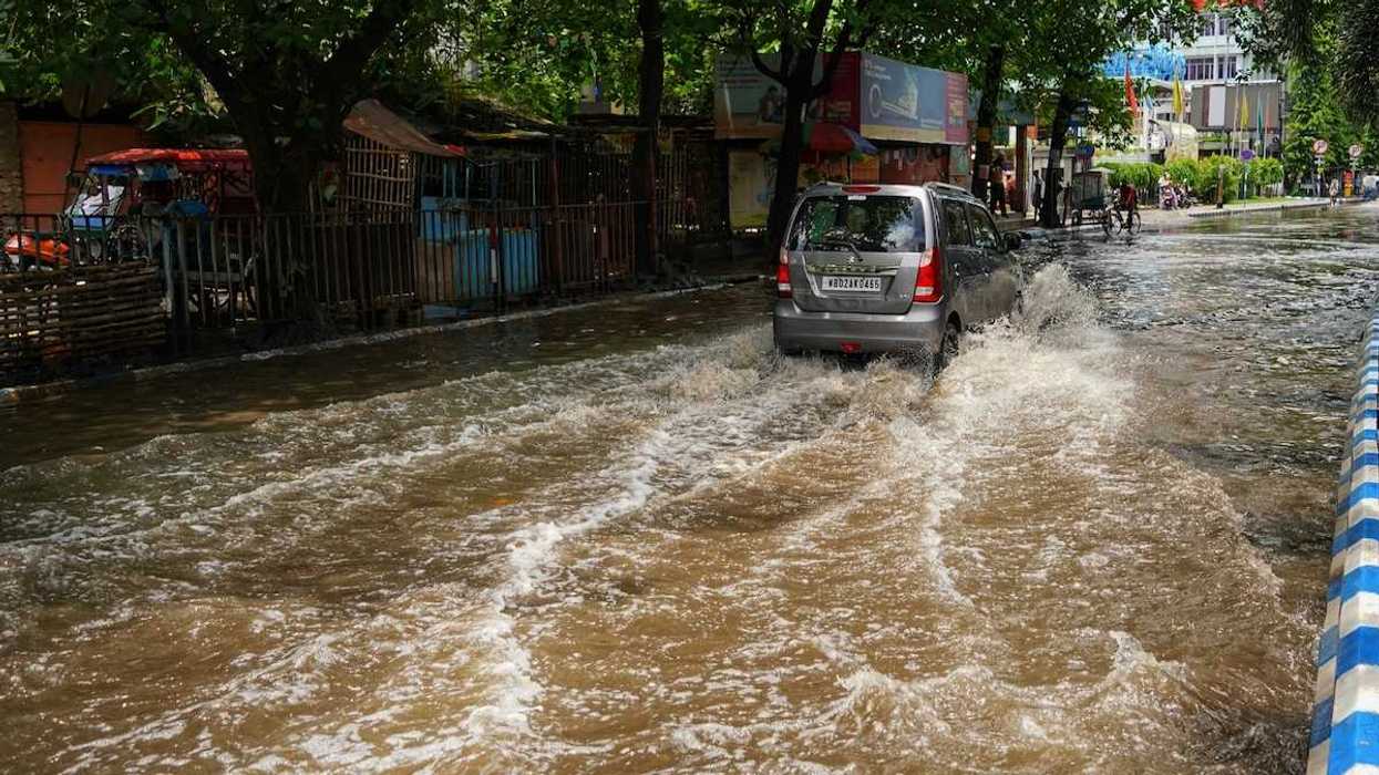 Van traveling on a flooded city street
