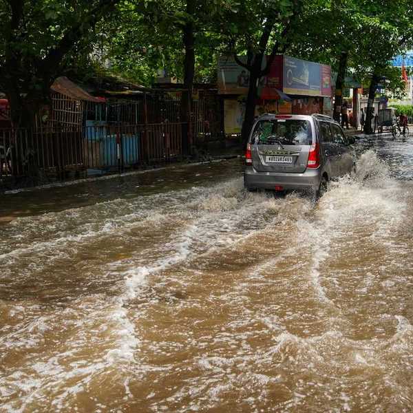 Van traveling on a flooded city street