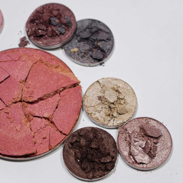 various powder cosmetics in different colors with lots of cracks and crumbles.