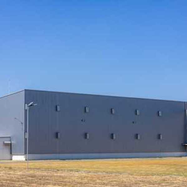 View of the exterior of a gray warehouse type building