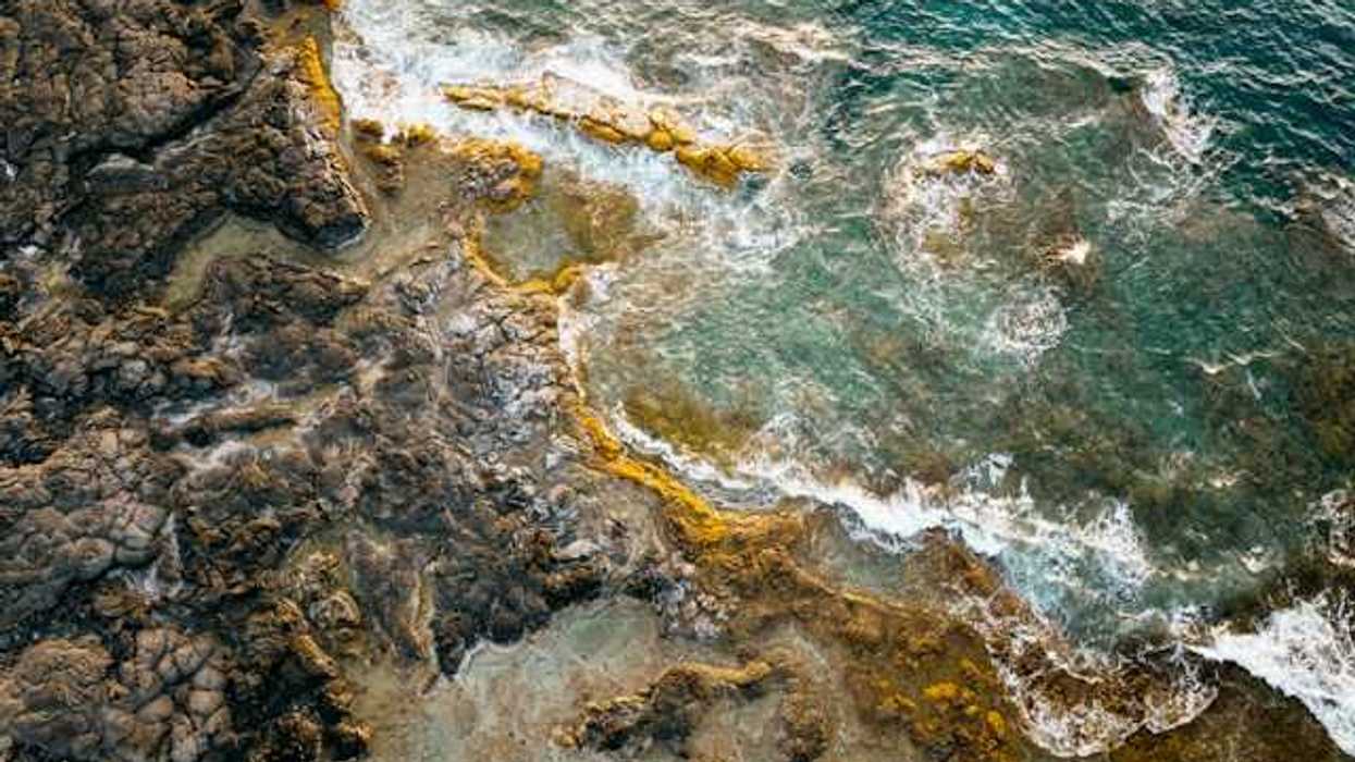 Volcanic rock coastline with ocean waves