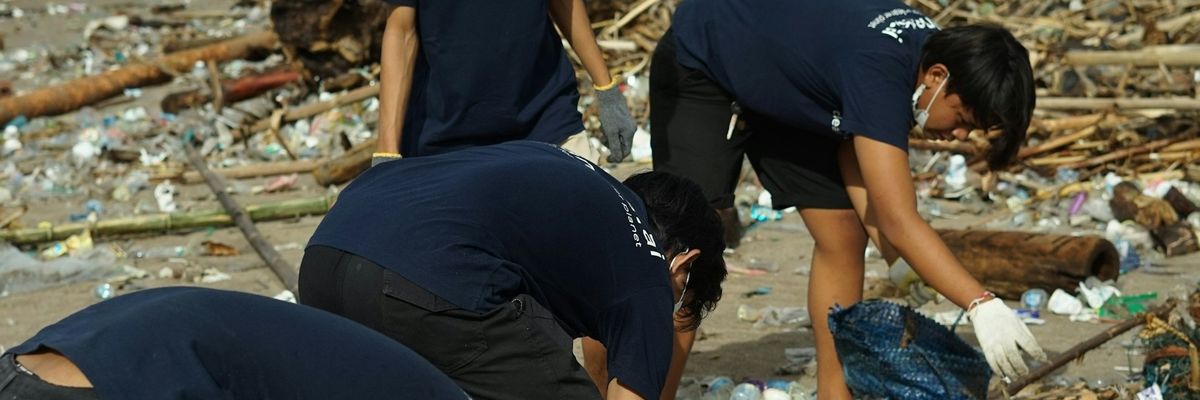 Volunteers recycling plastic beach trash.