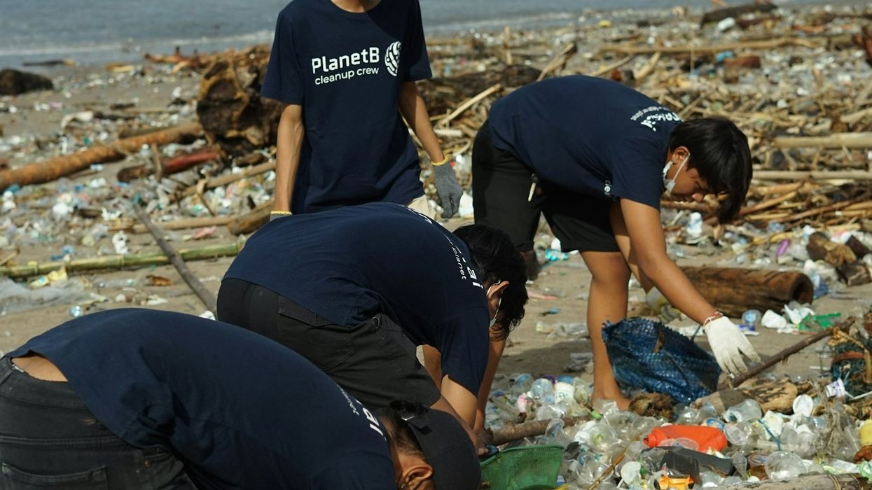 Volunteers recycling plastic beach trash.