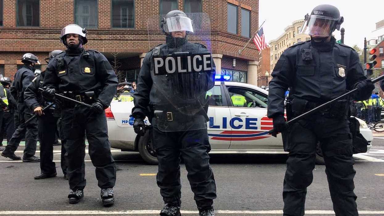 Washington DC police in riot gear brandishing clubs and other riot gear
