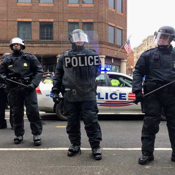 Washington DC police in riot gear brandishing clubs and other riot gear