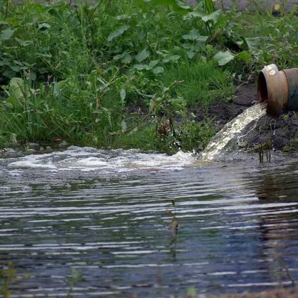 wastewater discharging into a waterway from pipe