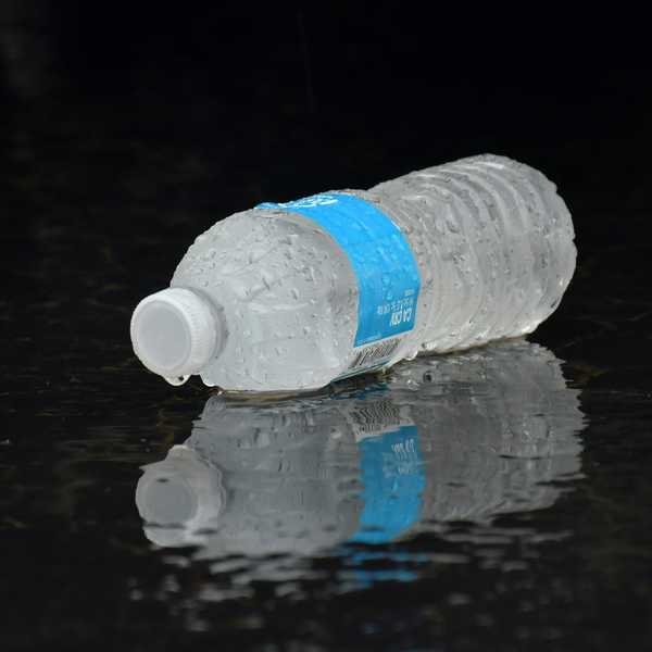 water plastic bottle on a black surface