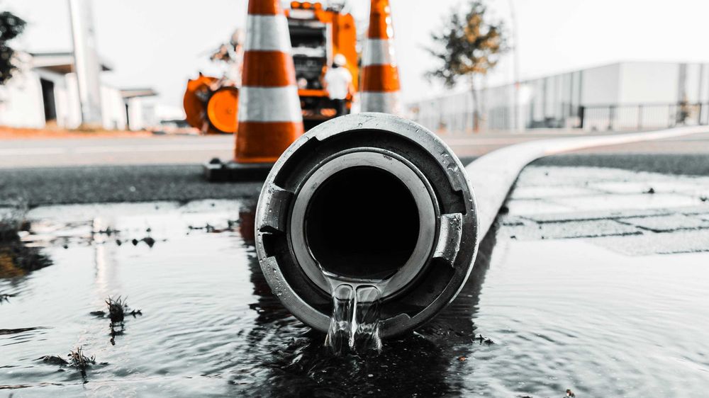 Water spills out of a plastic pipe