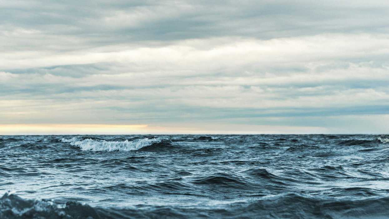 Waves in the sea under gray sky.