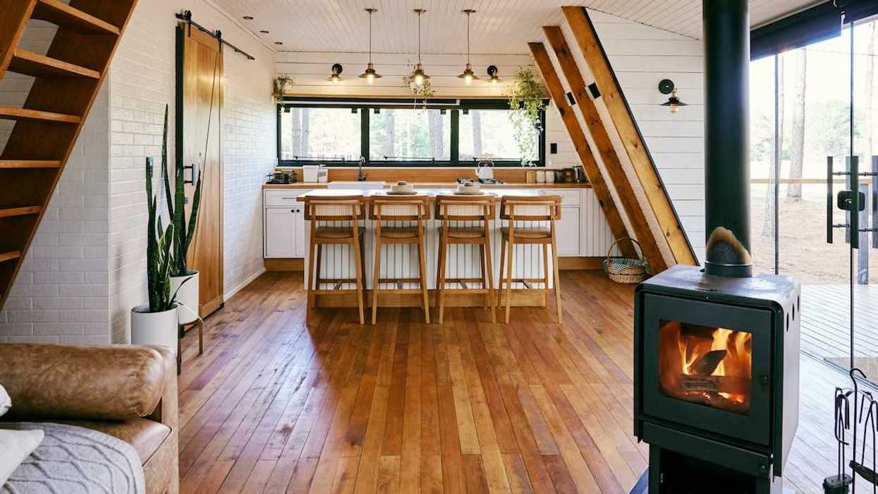 Well-lit home interior heated by wood-burning stove
