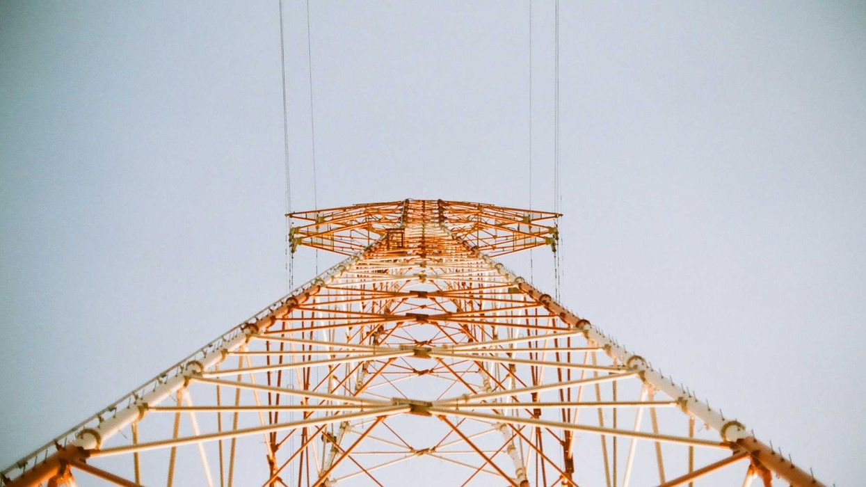 white and brown metal utility tower viewed from below