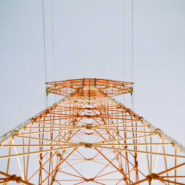 white and brown metal utility tower viewed from below