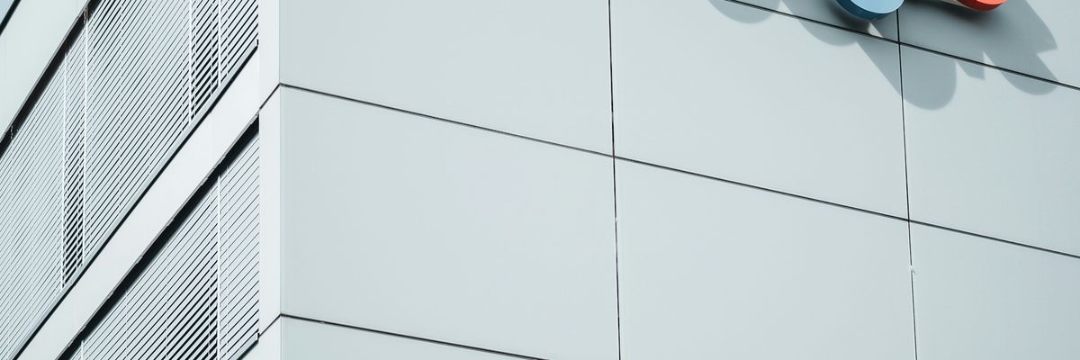 white concrete building during daytime with the Google logo on the side.