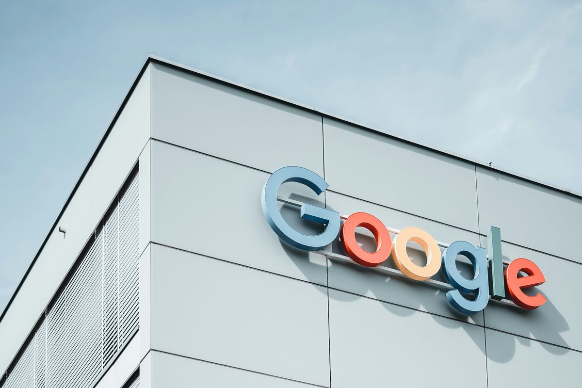 white concrete building during daytime with the Google logo on the side.