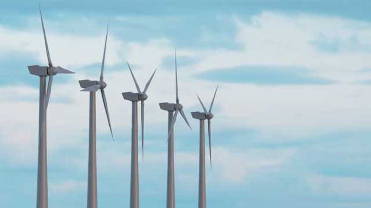 Wind turbines in a row against a blue sky
